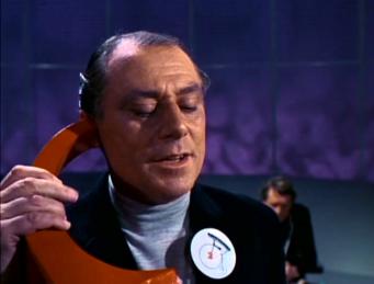 The sadistic No.2 on the phone to his master...